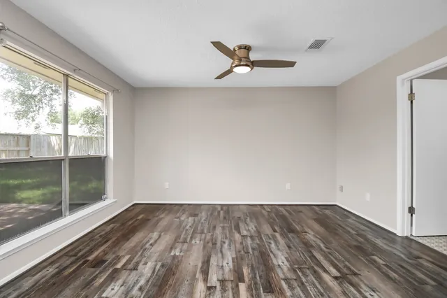 wooden floor in an empty room with a window