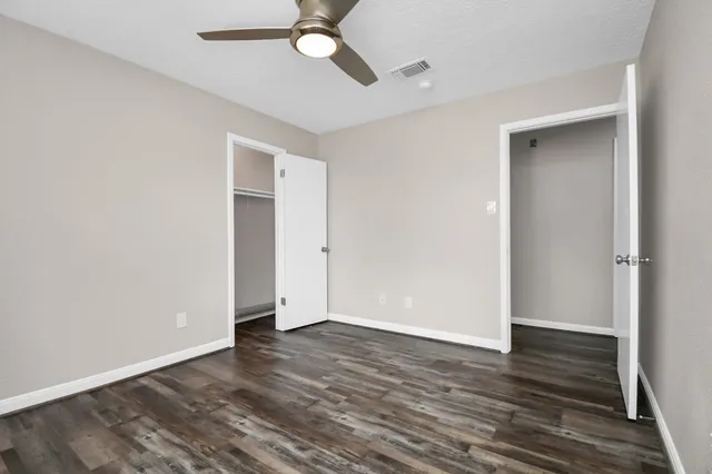 a view of kitchen with cabinets appliances and wooden floor