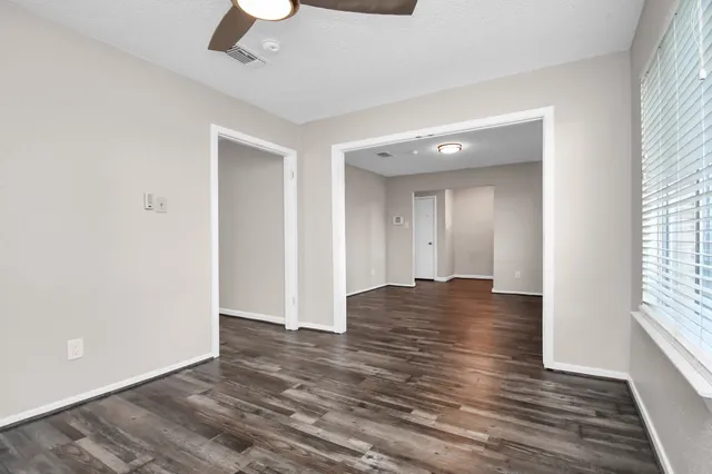 wooden floor in an empty room with a window