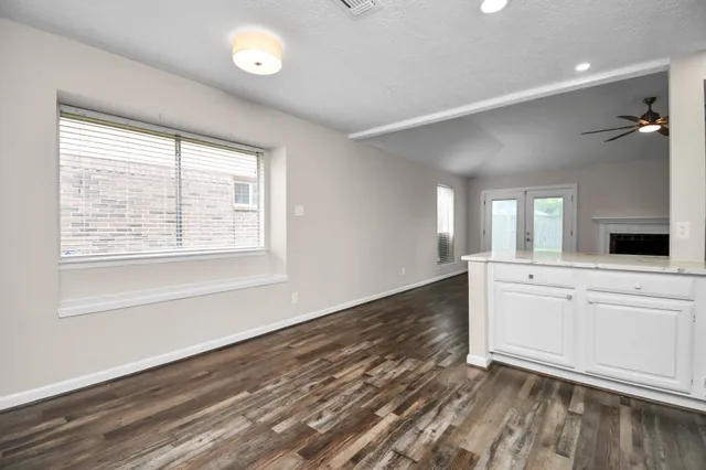a view of a kitchen with a dishwasher cabinets and a wooden floor