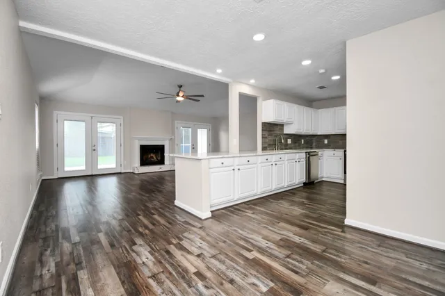 a view of a kitchen with a sink and a stove top oven