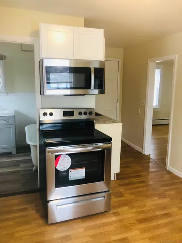 a stove top oven sitting inside of a kitchen