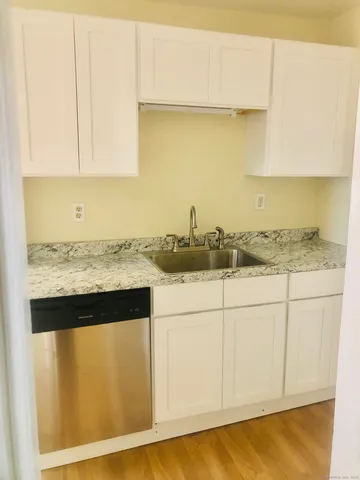 a kitchen with granite countertop cabinets and white appliances
