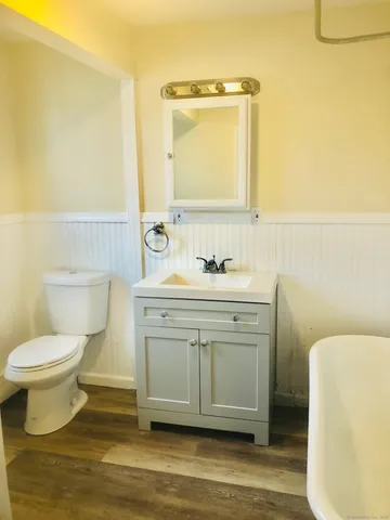 a bathroom with a sink toilet and mirror