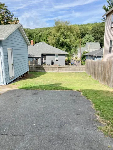 a view of a house with a yard and a patio
