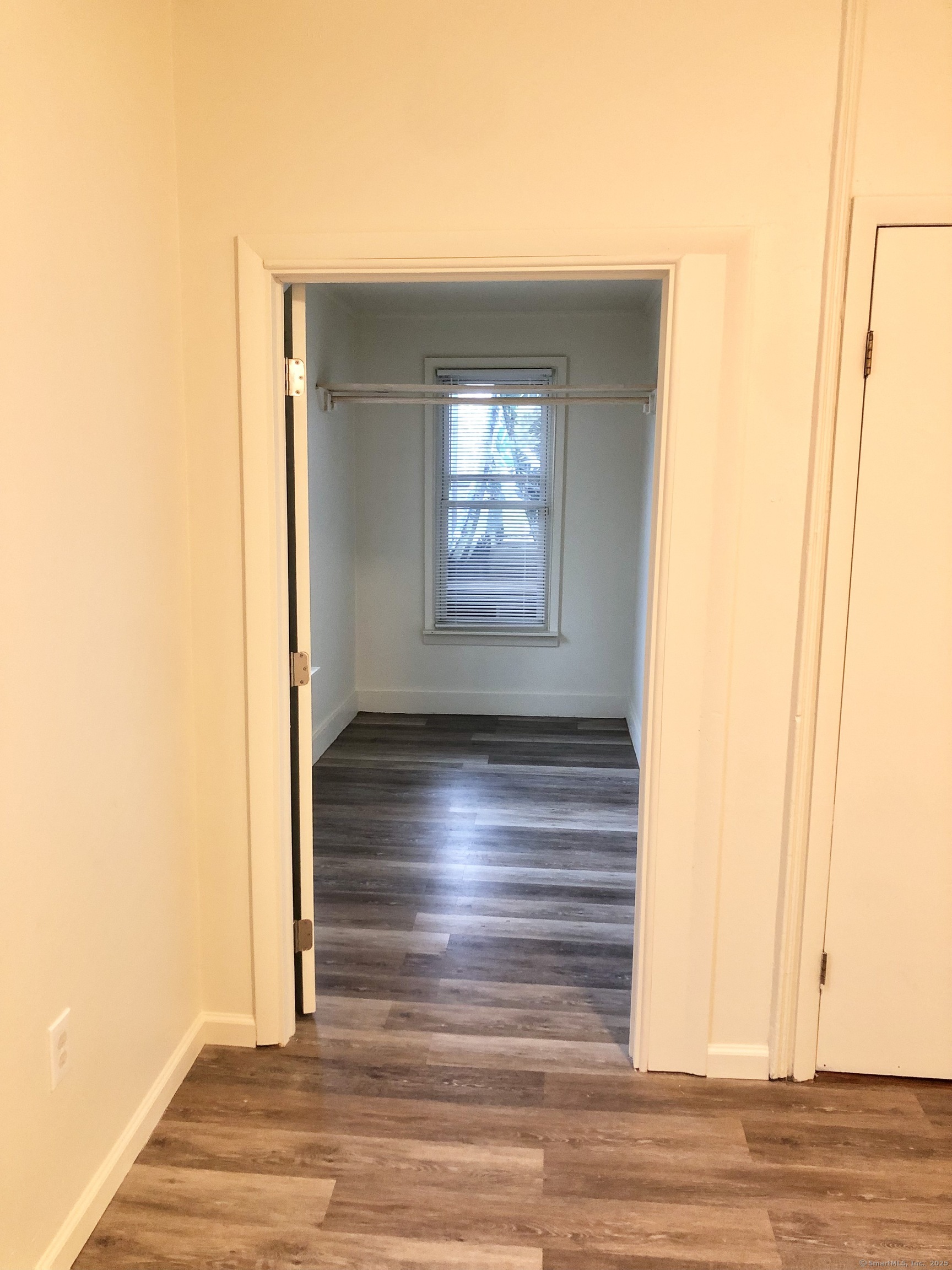 13 Tomlinson Street Ansonia, CT 06401 - Photo 9 of 21 a view of empty room with window and wooden floor