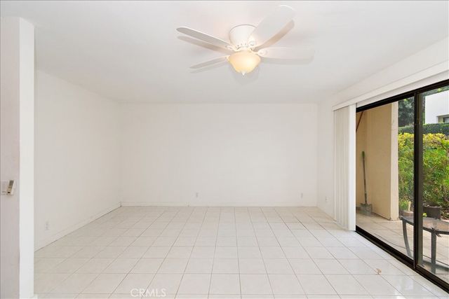 an empty room with windows and city view