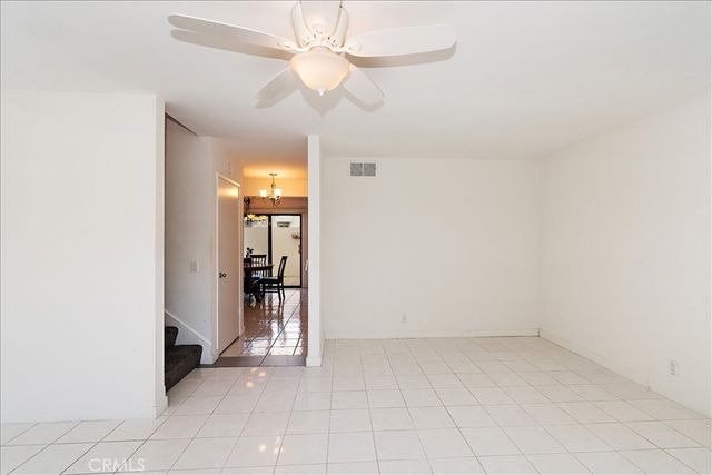 an empty room with a ceiling fan and a bathroom