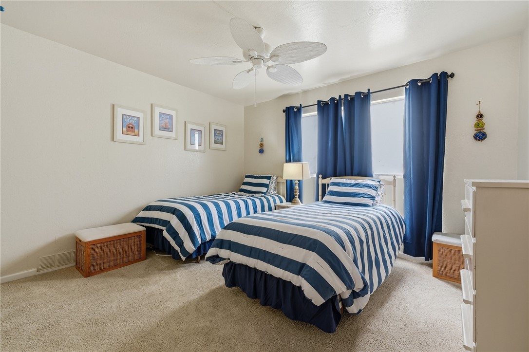 2003 North Fulton Beach Road, Unit 34 34 Rockport, TX 78382 - Photo 12 of 38 a bedroom with bed and a chandelier