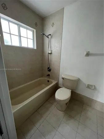 a bathroom with a toilet and a bathtub