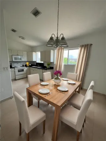 a view of a dining room with furniture window and outside view