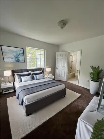a spacious bedroom with bed and window