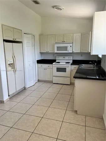 a kitchen with cabinets and appliances