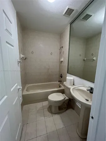a bathroom with a sink a toilet and bathtub
