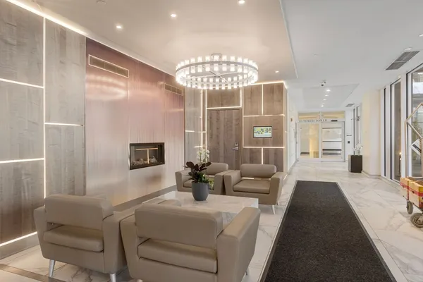 a living room with furniture and a chandelier