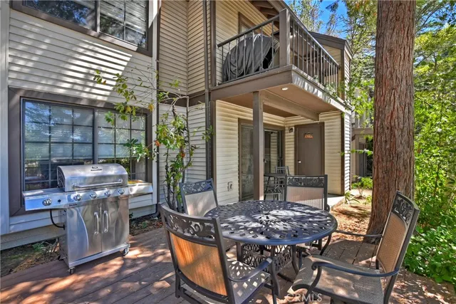 a view of a patio with table and chairs and potted plants