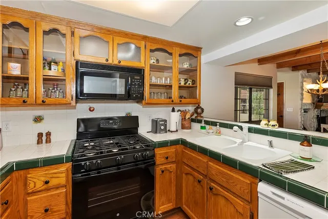 a kitchen with a stove a sink and a microwave