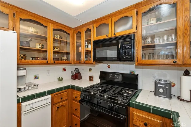 a kitchen with stainless steel appliances granite countertop a stove and a microwave