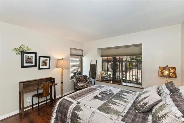 a bed sitting in a bedroom next to a window