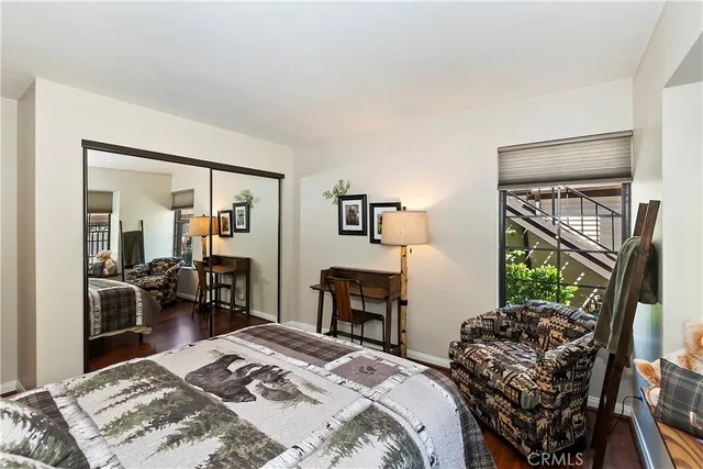 a bedroom with a bed a table and chair