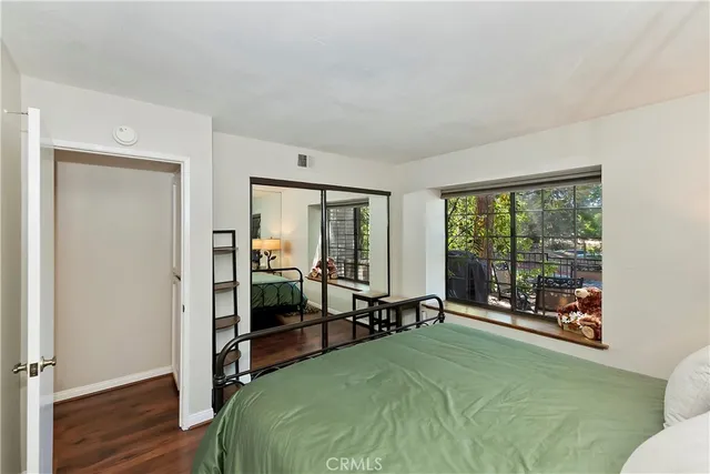 a bed room with a bed and a large window