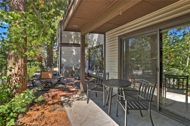 a view of a patio with table and chairs and potted plants