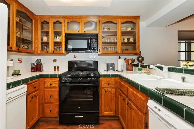 a kitchen with stainless steel appliances granite countertop a stove and a sink