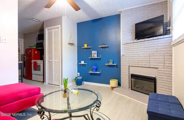 a living room with furniture and a fireplace