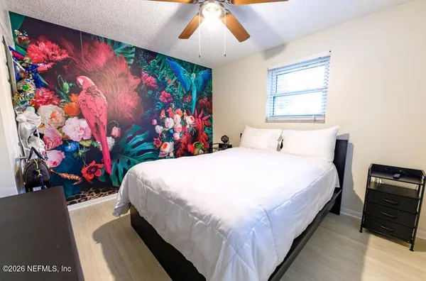 a bed sitting in a bedroom next to a window