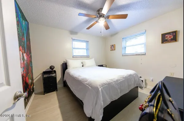 a bedroom with a bed and a chandelier