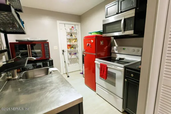 a kitchen with stainless steel appliances kitchen island a stove and a microwave