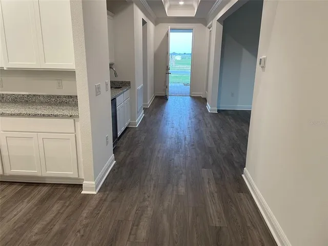 a view of hallway with wooden floor