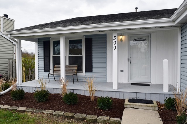 309 Hopi Court Carol Stream, IL 60188 - Photo 2 of 25 a front view of a house with potted plants and a bench