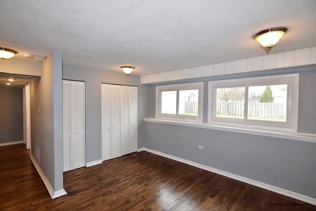 309 Hopi Court Carol Stream, IL 60188 - Photo 11 of 25 a view of an empty room with wooden floor and a window