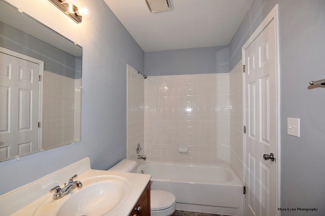 309 Hopi Court Carol Stream, IL 60188 - Photo 20 of 25 a bathroom with a bathtub shower sink vanity and toilet