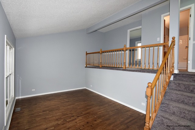 309 Hopi Court Carol Stream, IL 60188 - Photo 5 of 25 a view of a hallway with wooden floor and staircase