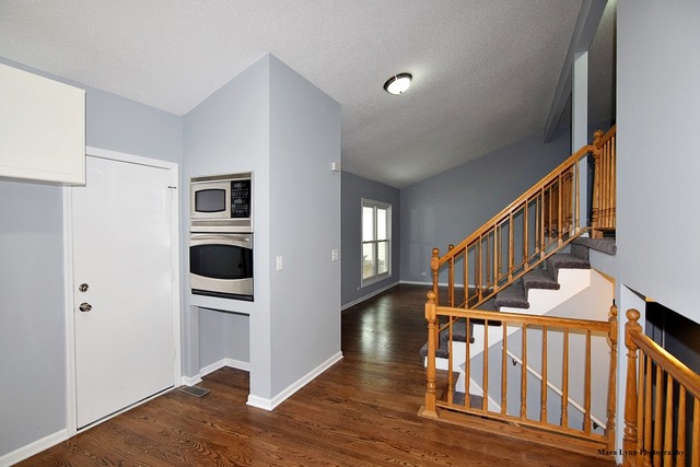 309 Hopi Court Carol Stream, IL 60188 - Photo 6 of 25 a view of entryway and hall with wooden floor
