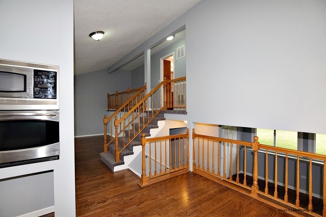 309 Hopi Court Carol Stream, IL 60188 - Photo 7 of 25 a view of entryway and hall with wooden floor