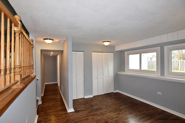 309 Hopi Court Carol Stream, IL 60188 - Photo 10 of 25 wooden floor in an empty room with a window