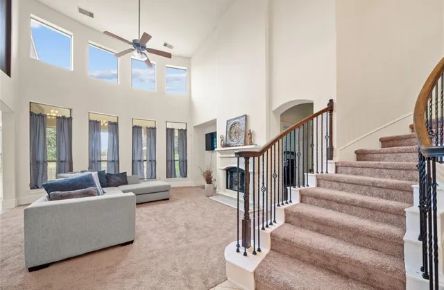 a view of a livingroom with furniture and staircase