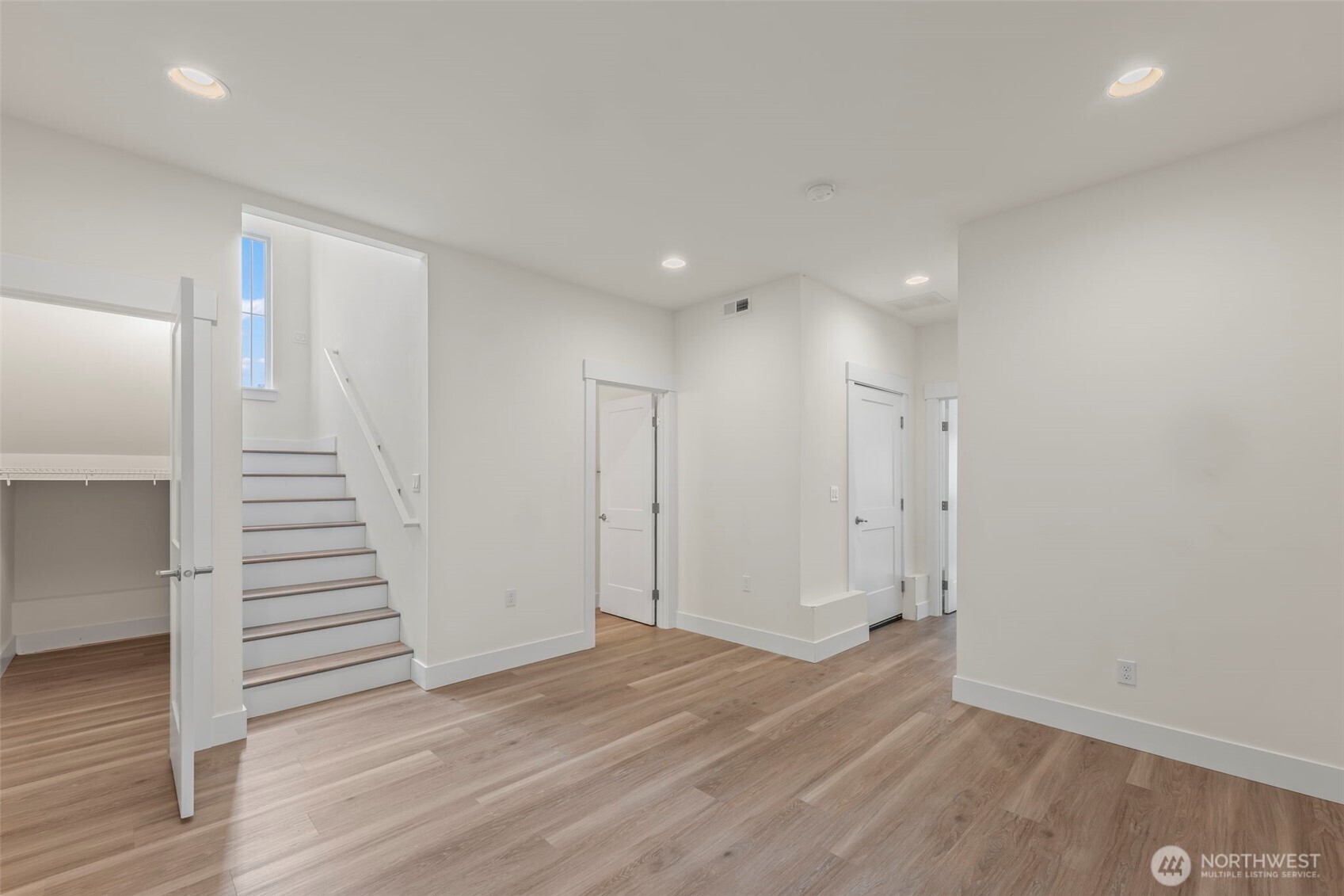 19017 Highway 3, Unit AB Allyn, WA 98524 - Photo 5 of 31 an empty room with wooden floor and entryway