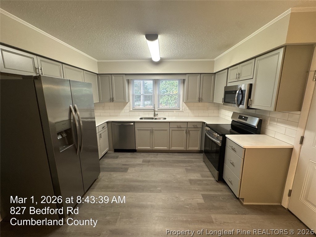 825 Bedford Road Fayetteville, NC 28303 - Photo 8 of 26 a kitchen with stainless steel appliances granite countertop a sink stove and refrigerator