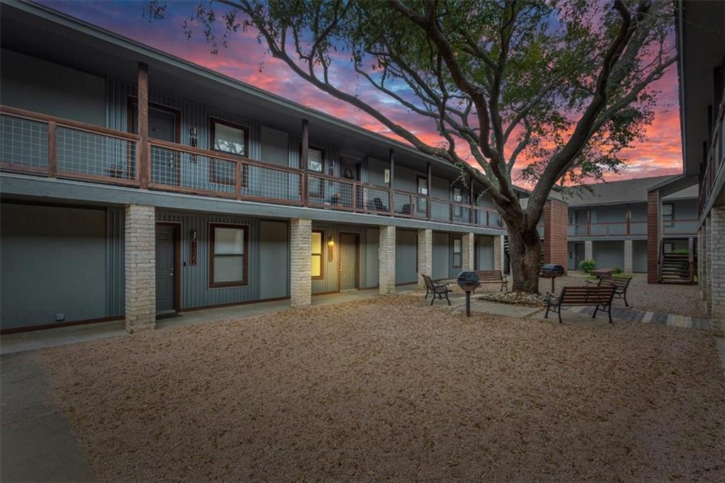 a view of a building with sitting area