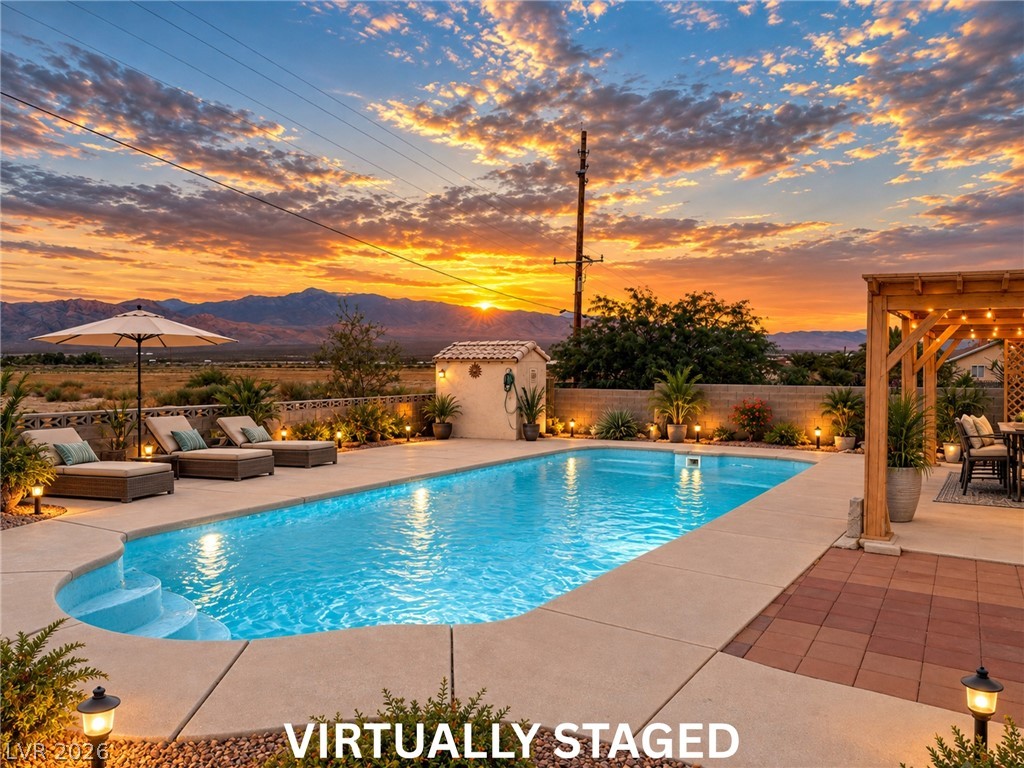 5470 Grain Mill Road Pahrump, NV 89061 - Photo 56 of 80 VIRTUALLY STAGED An inviting swimming pool overlooks sweeping mountain ranges and vibrant desert sunsets.