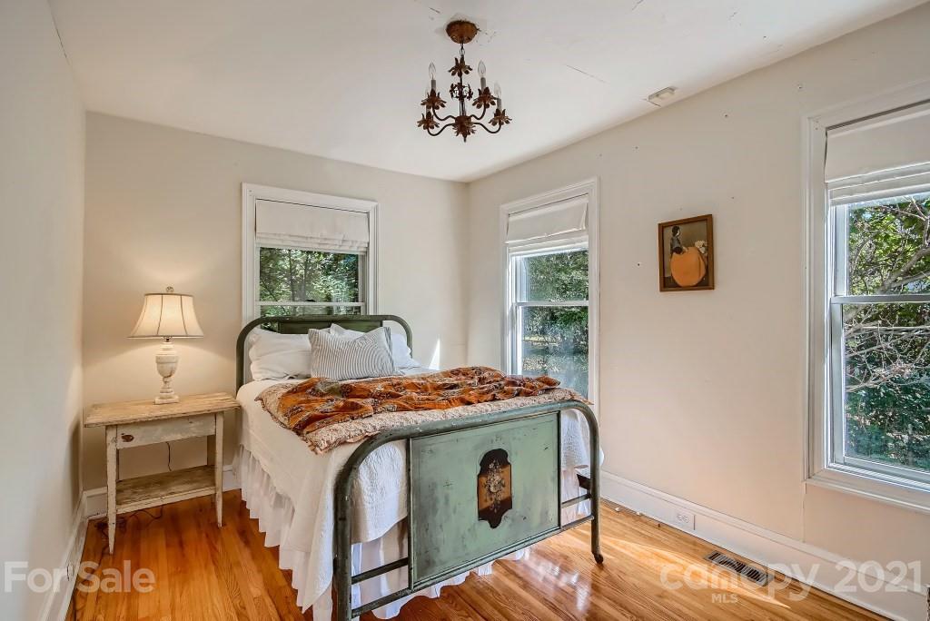 501 Marsh Road Charlotte, NC 28209 - Photo 12 of 27 a bed sitting in a bedroom next to a window