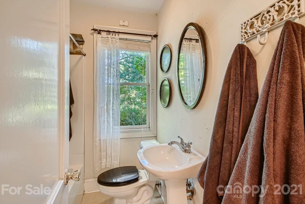 501 Marsh Road Charlotte, NC 28209 - Photo 13 of 27 a bathroom with a sink toilet and a mirror