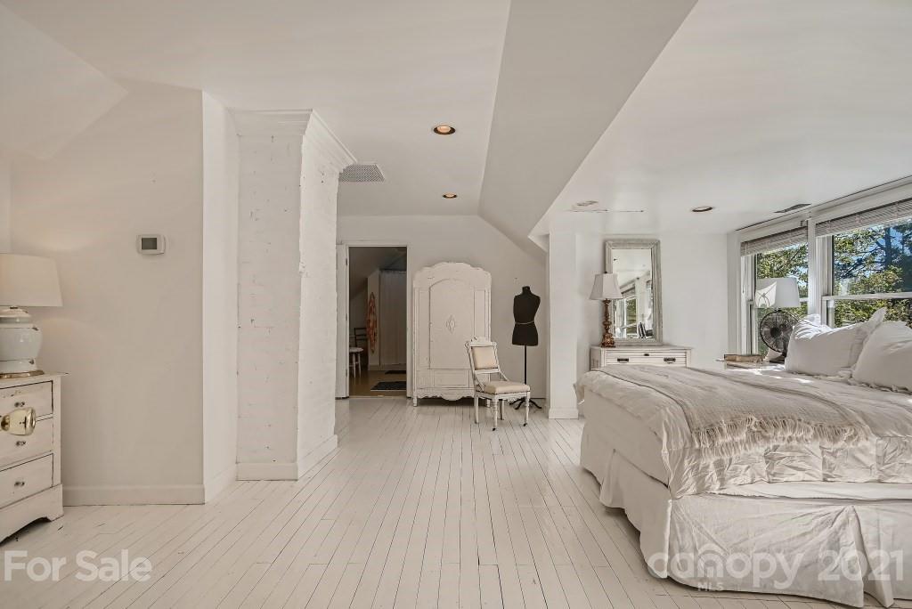 501 Marsh Road Charlotte, NC 28209 - Photo 14 of 27 a large white bed in a white room