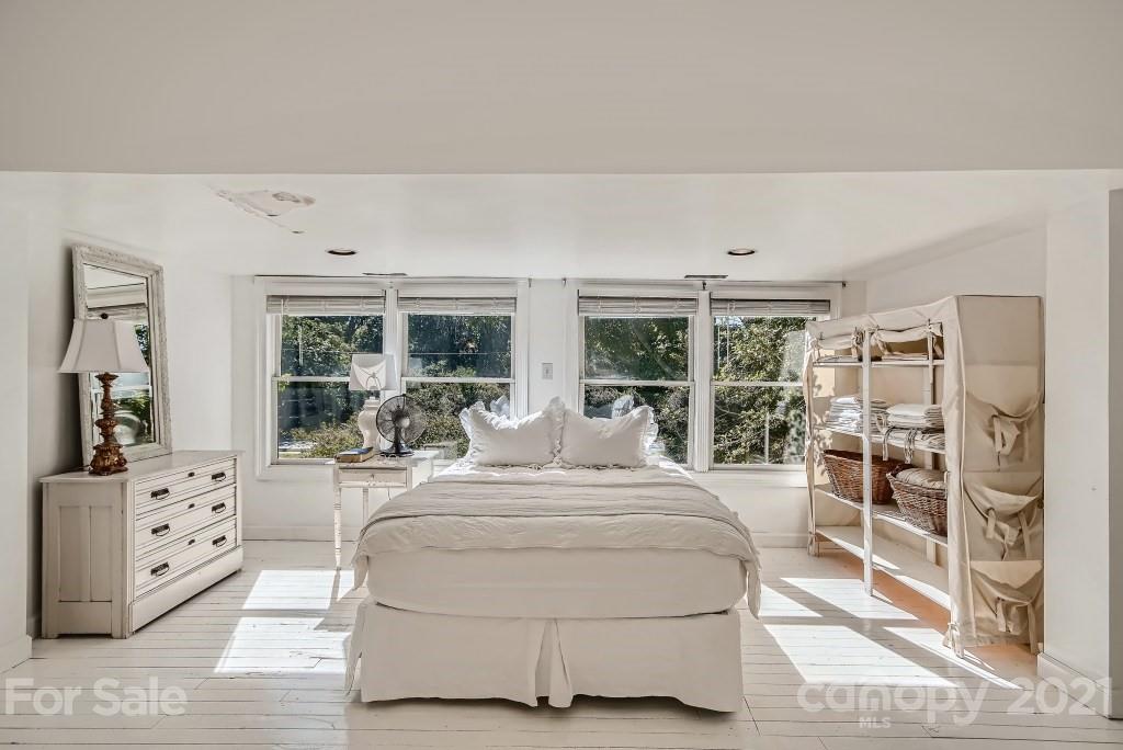 501 Marsh Road Charlotte, NC 28209 - Photo 15 of 27 a bedroom with a bed and a large window