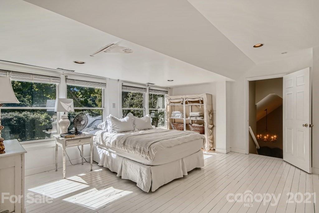 501 Marsh Road Charlotte, NC 28209 - Photo 16 of 27 a bedroom with a large bed and a large window
