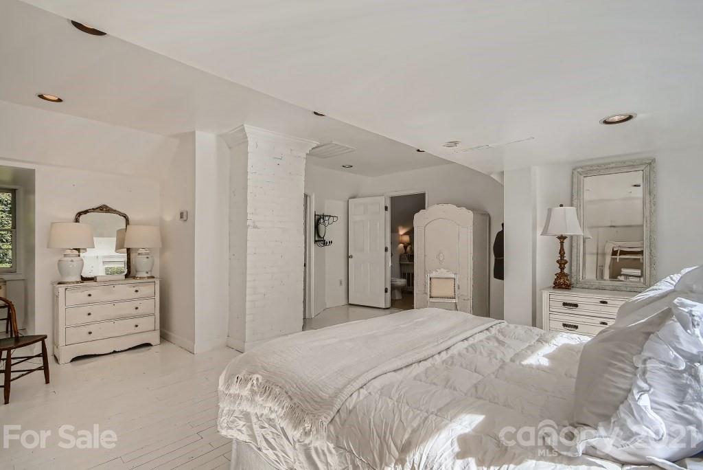 501 Marsh Road Charlotte, NC 28209 - Photo 17 of 27 a bedroom with a bed and a dresser